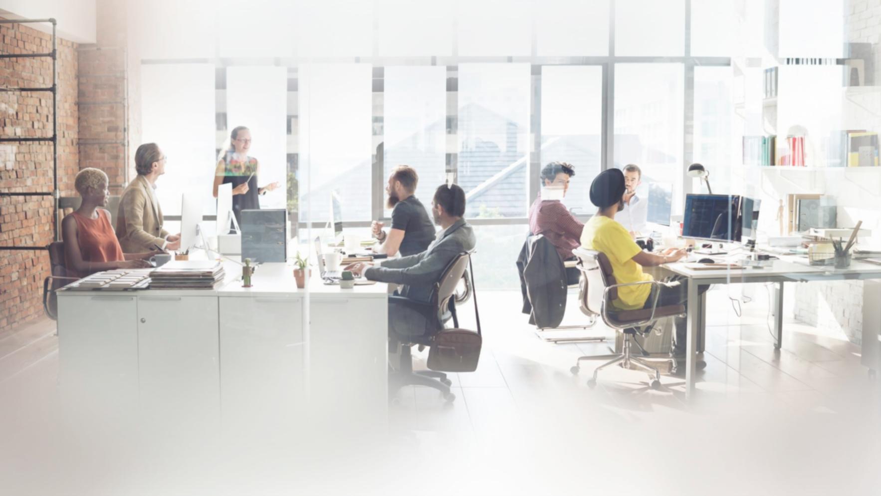 Modern office setup with financial charts and analysis reports displayed on screens